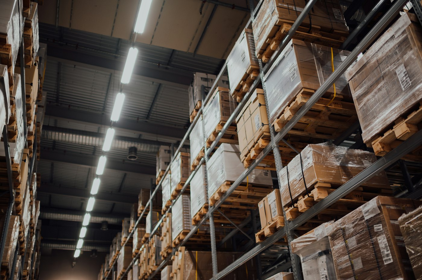 Cartons and wrapped pallets stored on warehouse shelving
