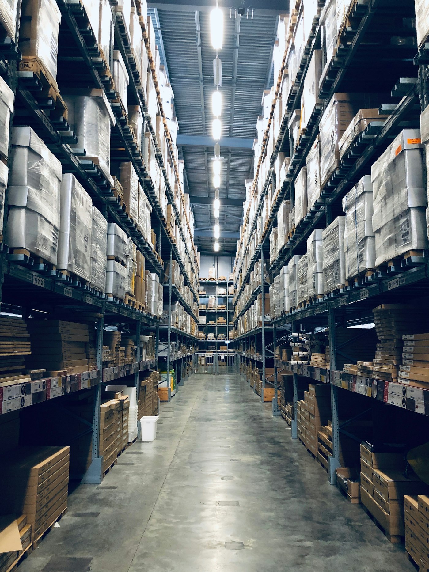 Tall warehouse racks lining a storage aisle
